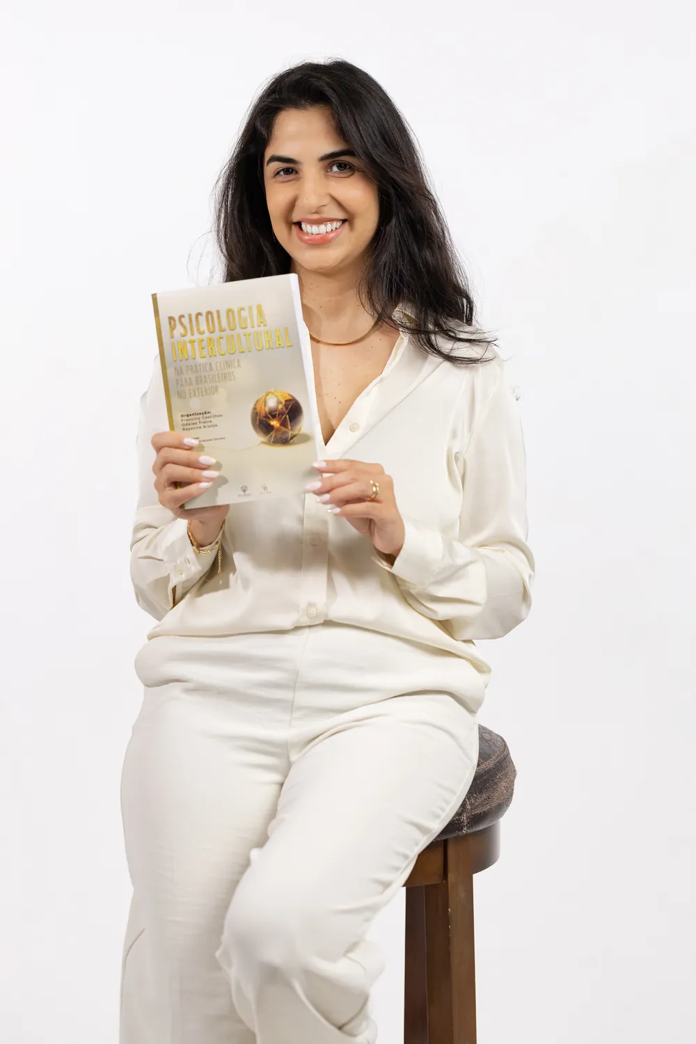 Autora do PSI Terapia no Exterior segurando o livro